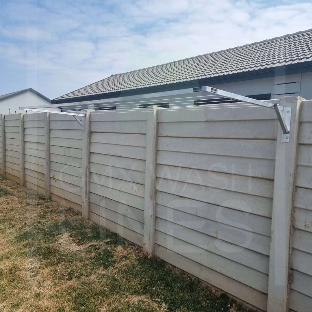 Wall-mounted washing line on a textured concrete wall.