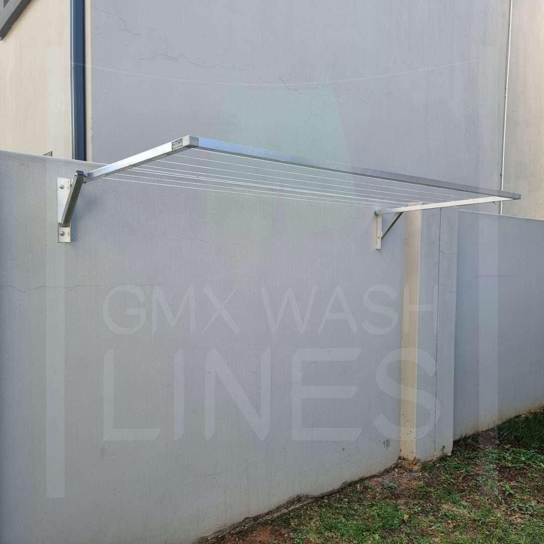 GMX Fold Away washing line on a grey wall with open space