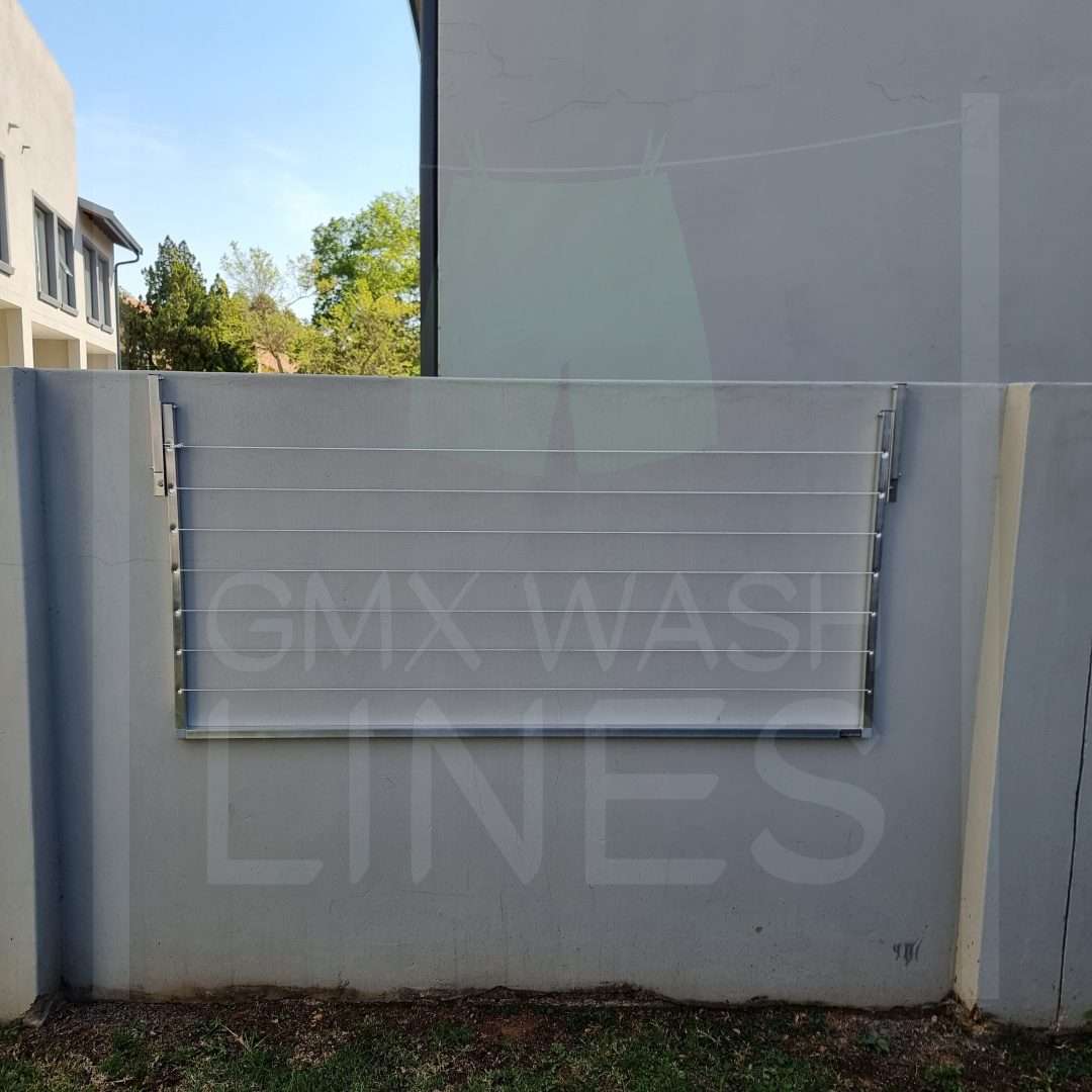 GMX Fold Away Range washing line installed on a plastered wall.