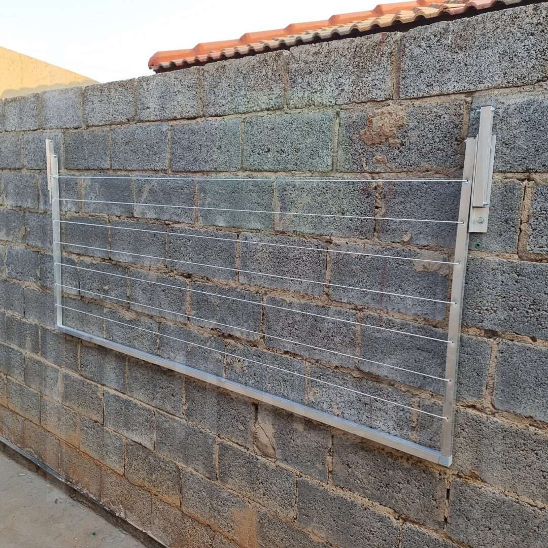 GMX wash line extended on a brick wall in a home backyard.