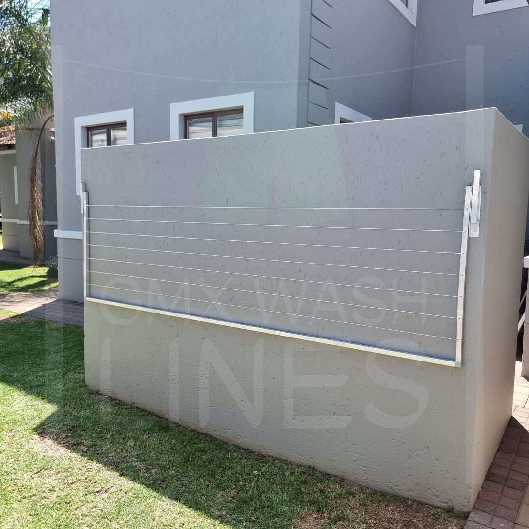 Aluminum GMX wash line mounted on a grey wall with shadows.