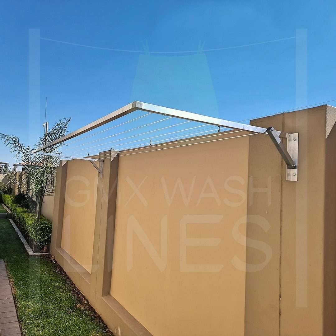 Wall Mounted Fold Away Washing Line against a blue sky.