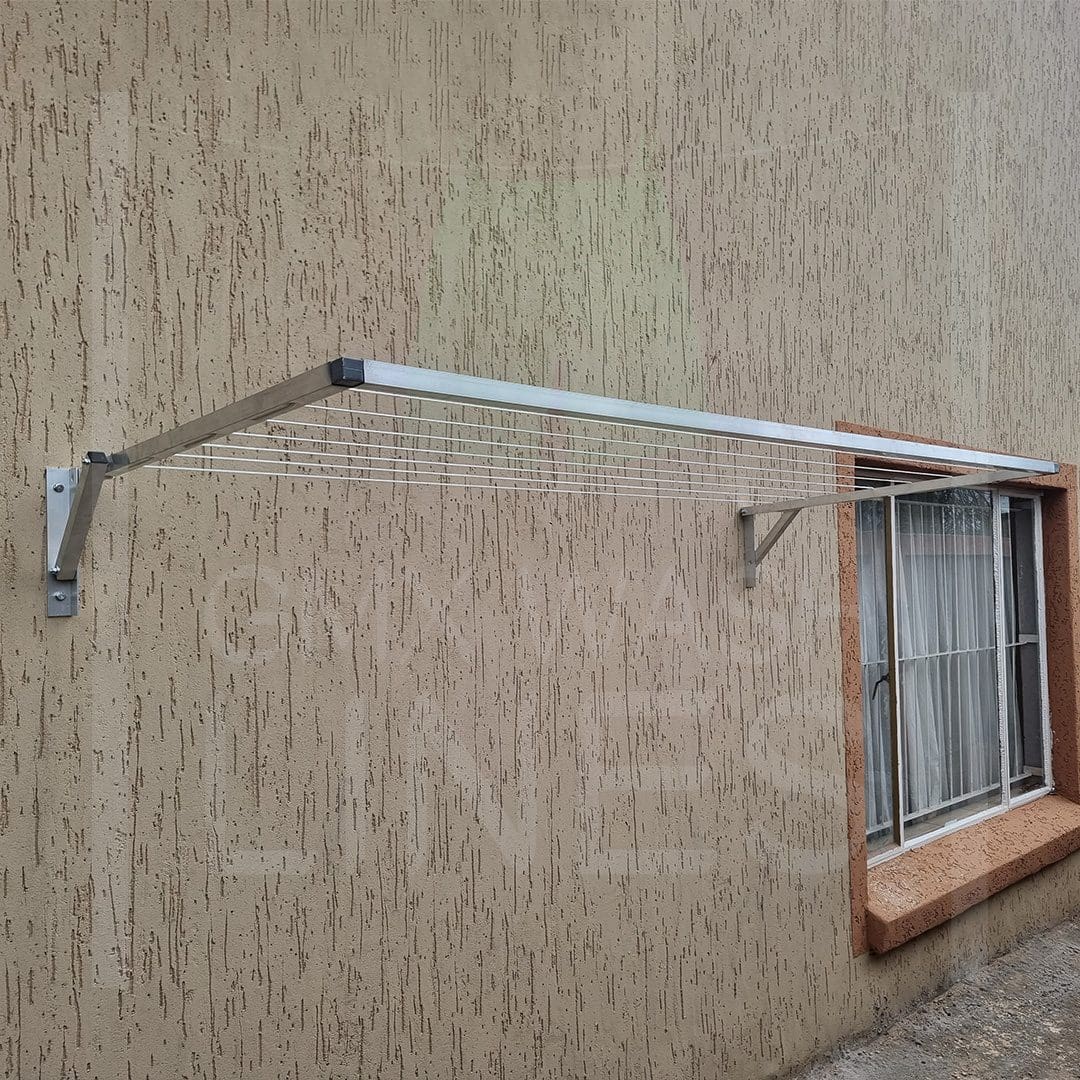 Sleek Wall Mountable Wash Line next to a window on a textured wall.