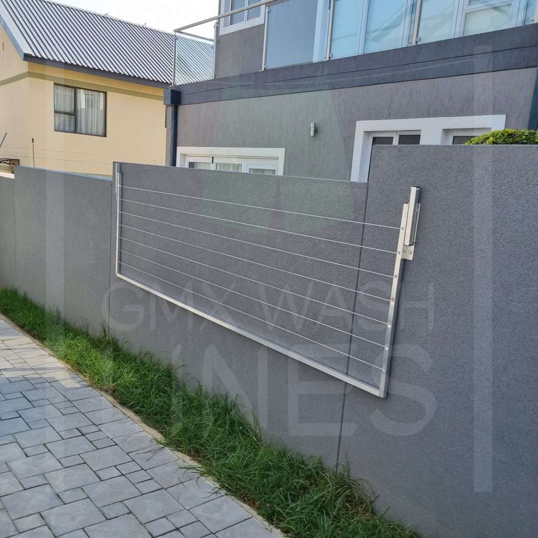 GMX Wall-mounted washing line displayed in folded position against a grey wall