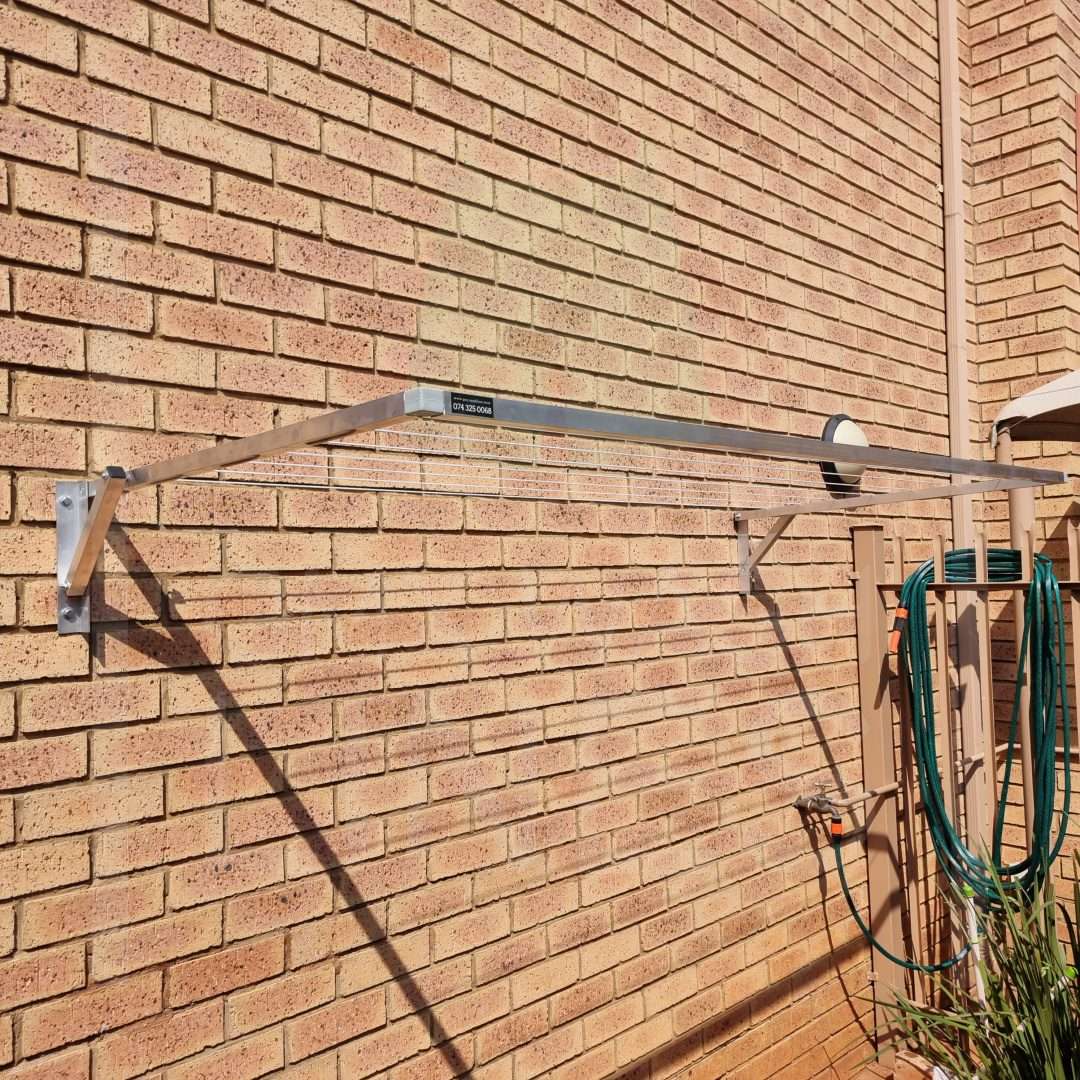 Aluminum wall-mounted wash line in a home garden